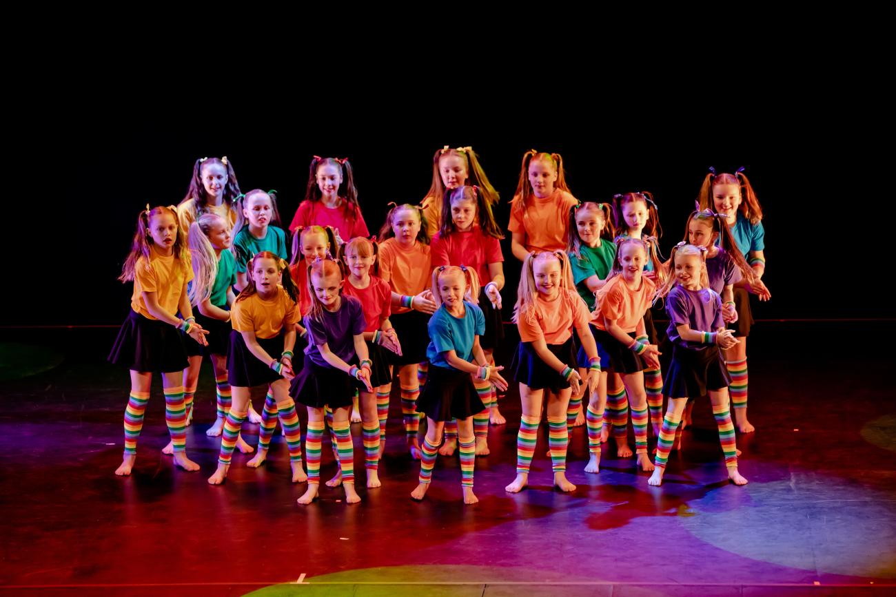 group of young dancers in a centre clump clapping with coloured tshirts and socks